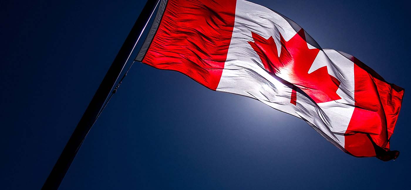 Canadian flag blows in the wind on a blue, sunny day!''